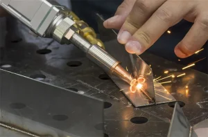 Close-up of handheld laser welding tool joining metal pieces