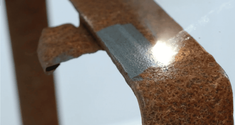 Laser cleaning machine removing rust from metal part