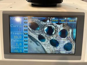Jewelry laser spot welder is in the process of repairing precious metals