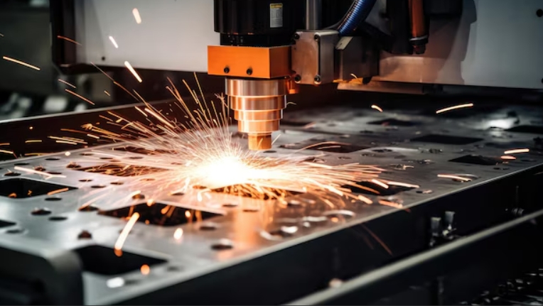 Modern fiber laser cutting machine processing sheet metal with sparks in factory