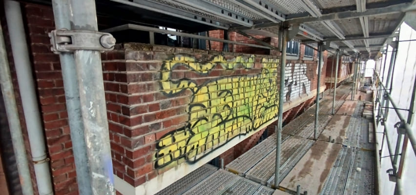 Graffiti on the wall needs to be cleaned