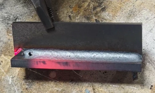 6000W handheld laser welding machine creating a clean weld seam on thick carbon steel plate